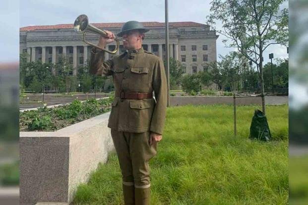 A WWI historical interpreter playing Taps