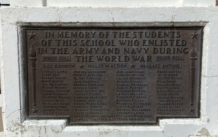 A concrete World War I memorial on the entry sidewalk at Memorial Hall includes a plaque with the names of 62 Phoenix Indian School students who enlisted in the Army and Navy. (Christina Estes/KJZZ)