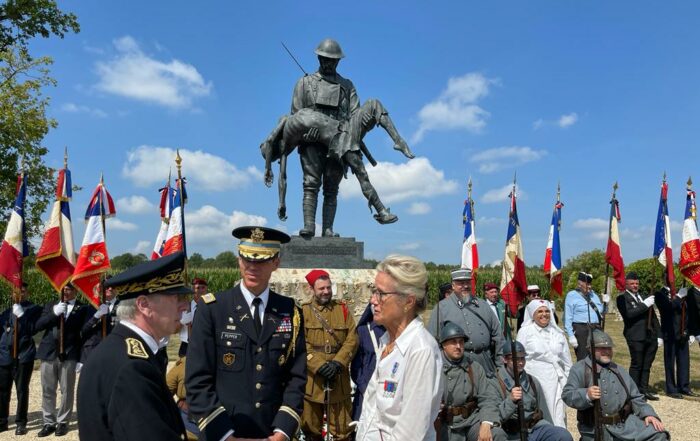 People stand in front of a WWI monument