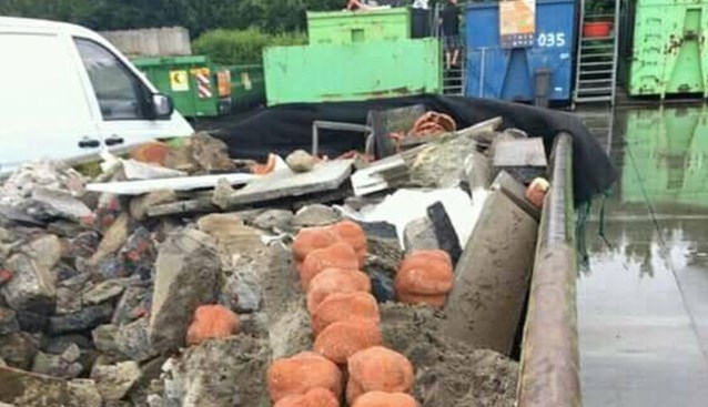 Clay figures disposed of in a dumpster