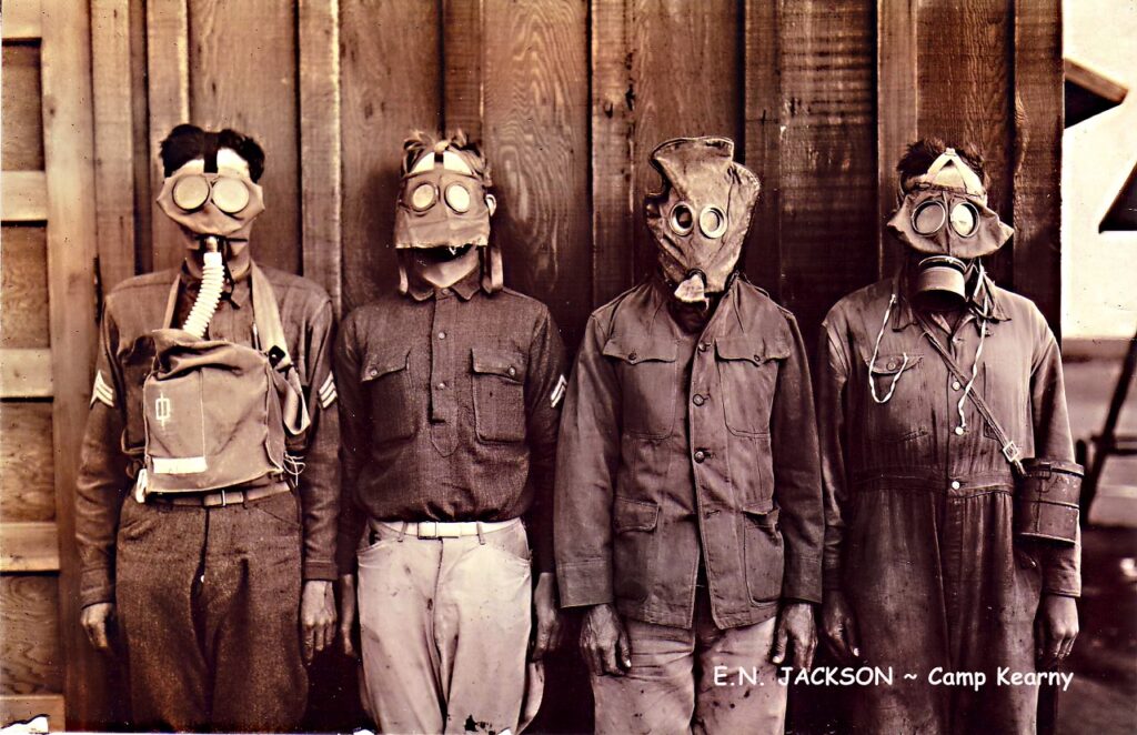 Four soldiers demonstrate gas masks