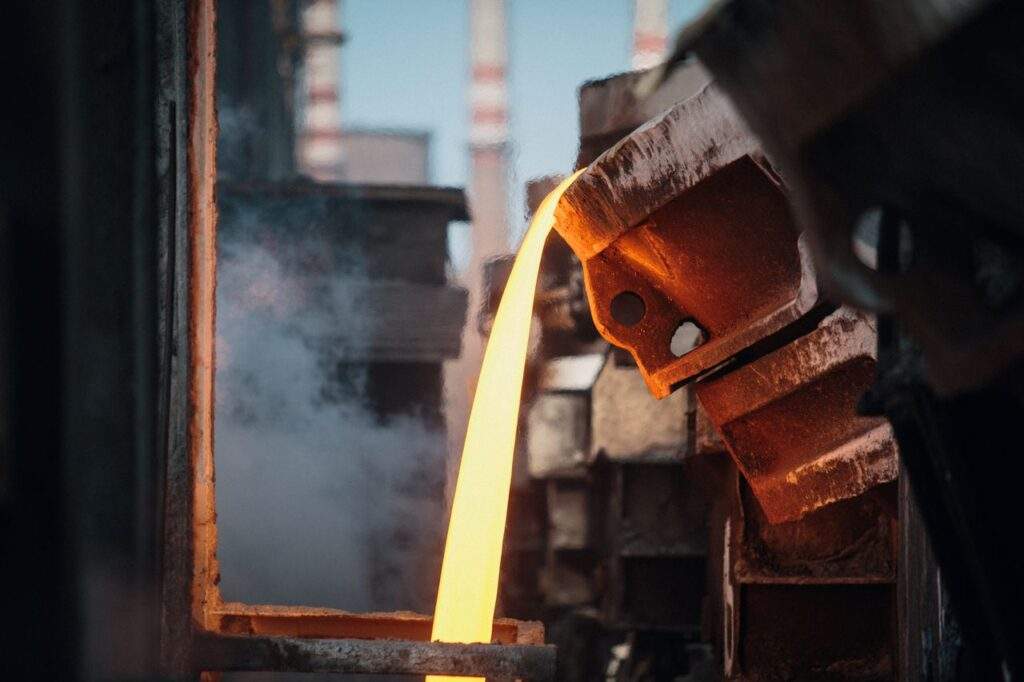 a close-up of molten metal pouring in a foundry
